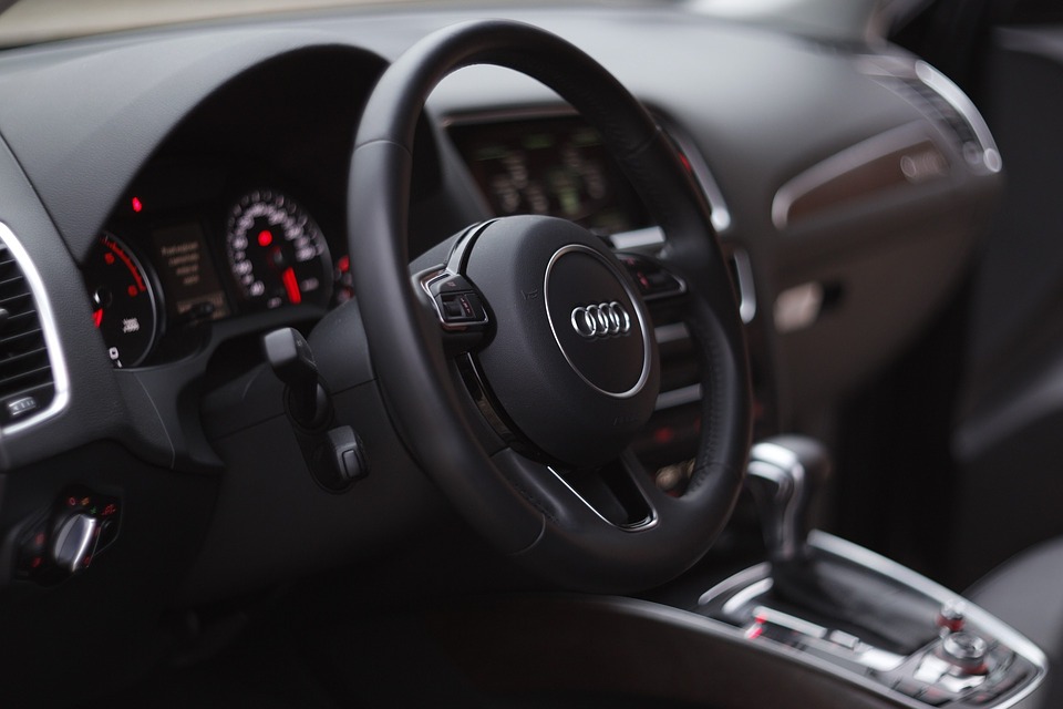 Close-up of Audi steering wheel, car interior, power steering, luxury vehicle dashboard, Audi features