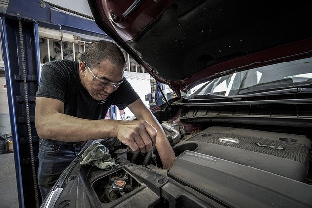 mechanic working on engine cooling system