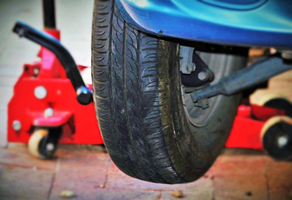 car tire lifted by car jack