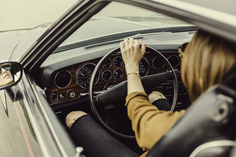 women sitting behind the wheel