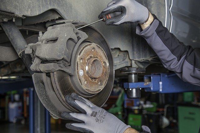 mechanic working on brake pads