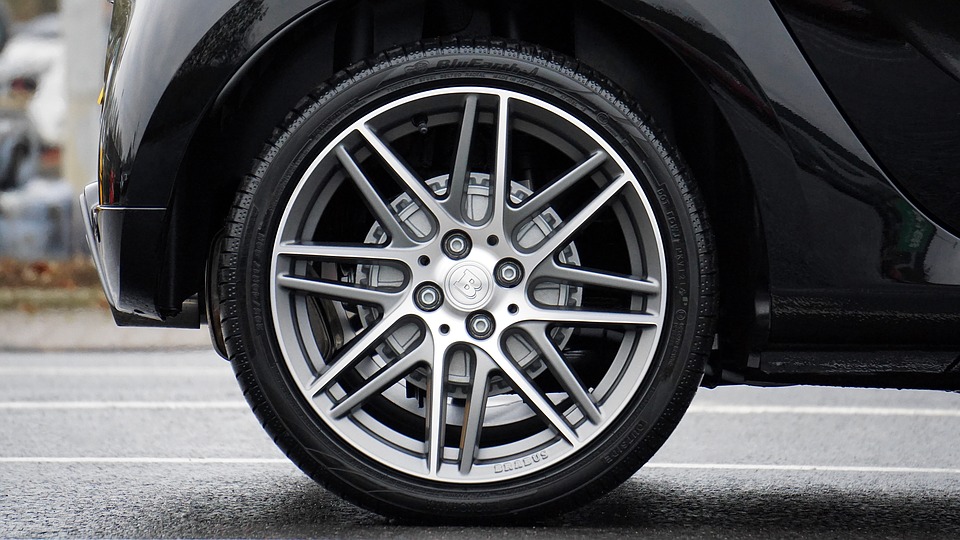 Close-up of a car wheel with alloy rims, highlighting automotive design and tire features