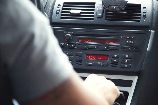 man sitting in car at dashboard