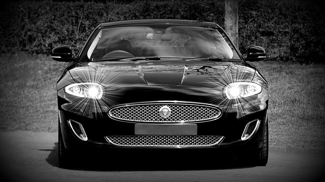 black and white image of a Jaguar shining headlights at camera, headlights, Jaguar, high beams