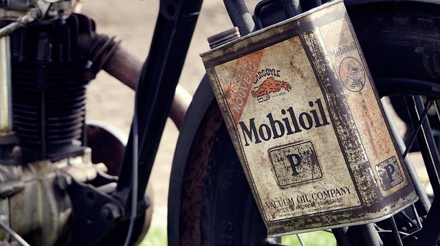 Vintage Mobiloil P can hanging on an old motorcycle, classic motor oil advertisement Vintage Mobiloil P can hanging on an old motorcycle, classic motor oil advertisement