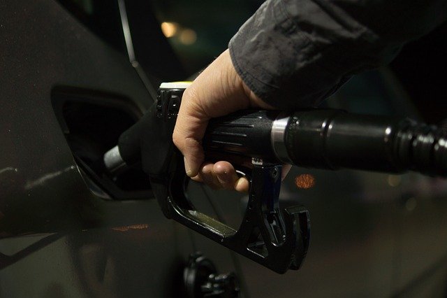 close-up of hand pumping gas