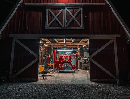 large red truck inside a barn showcasing winterizing a car, winterize car, winterized, store car